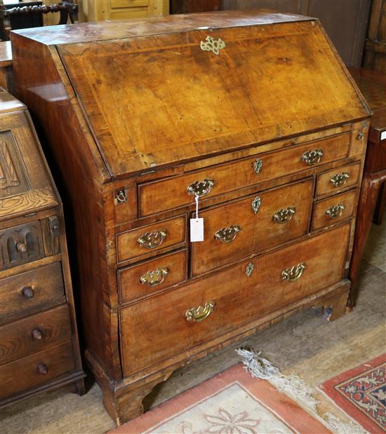 A George II featherbanded walnut bureau, W.3ft 4in. D.2ft H.3ft 7in,